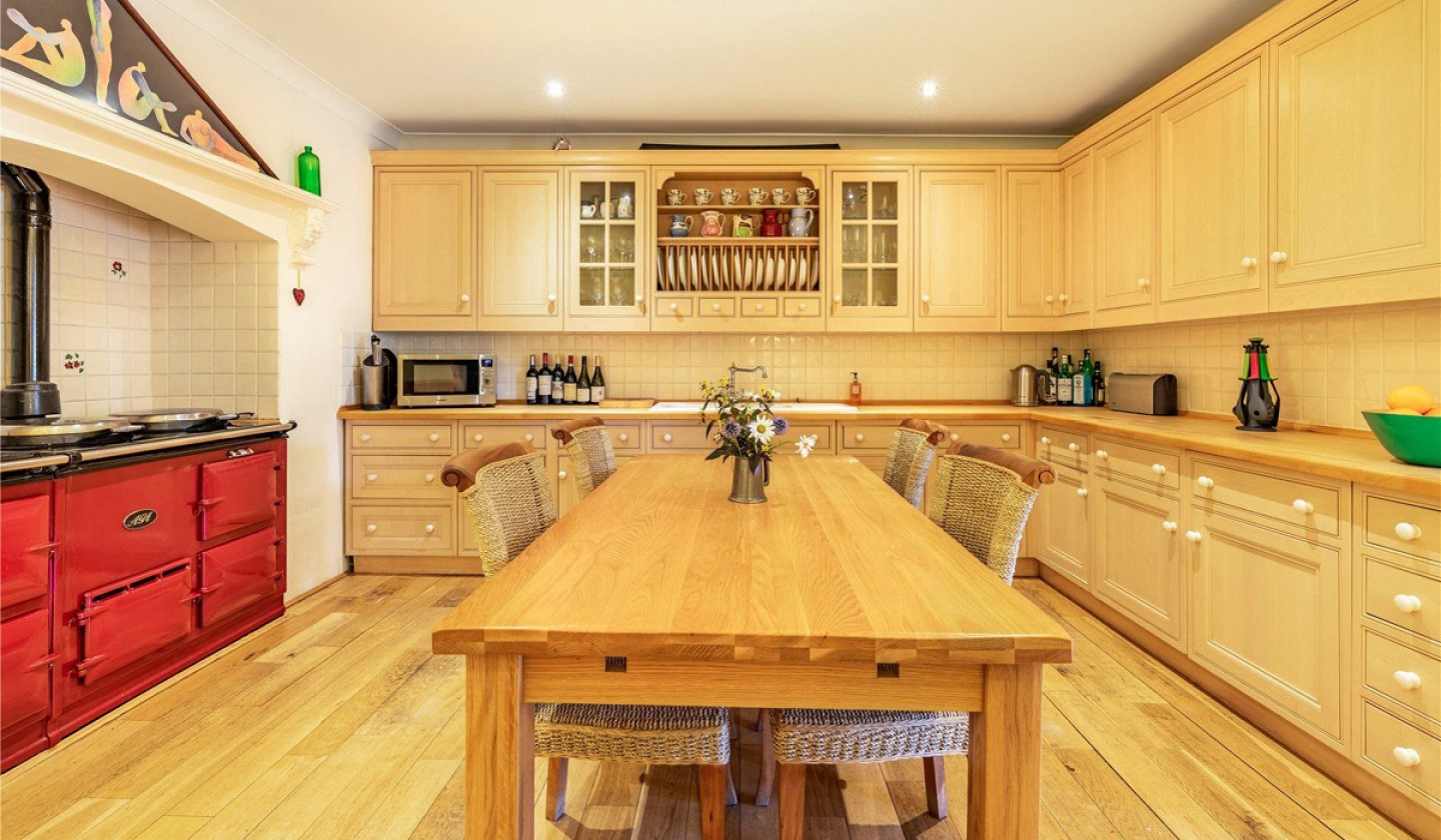 kitchen with cream cupboards and red range cooker